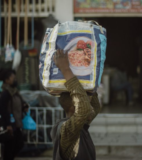 a person carrying a bag of food