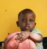 boy holding brown basketball