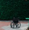 black bicycle parked beside green wall