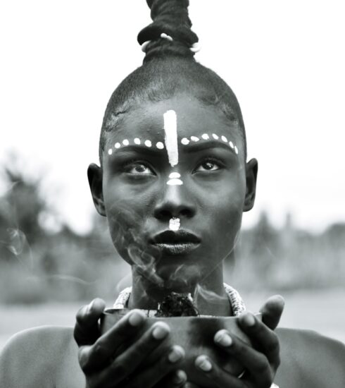 a woman holding a cigarette in her hands